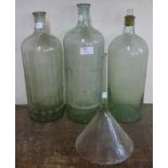 Three vintage glass poison bottles and a funnel
