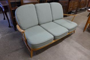 An Ercol Blonde beech Windsor settee