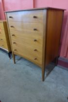 A teak chest of drawers