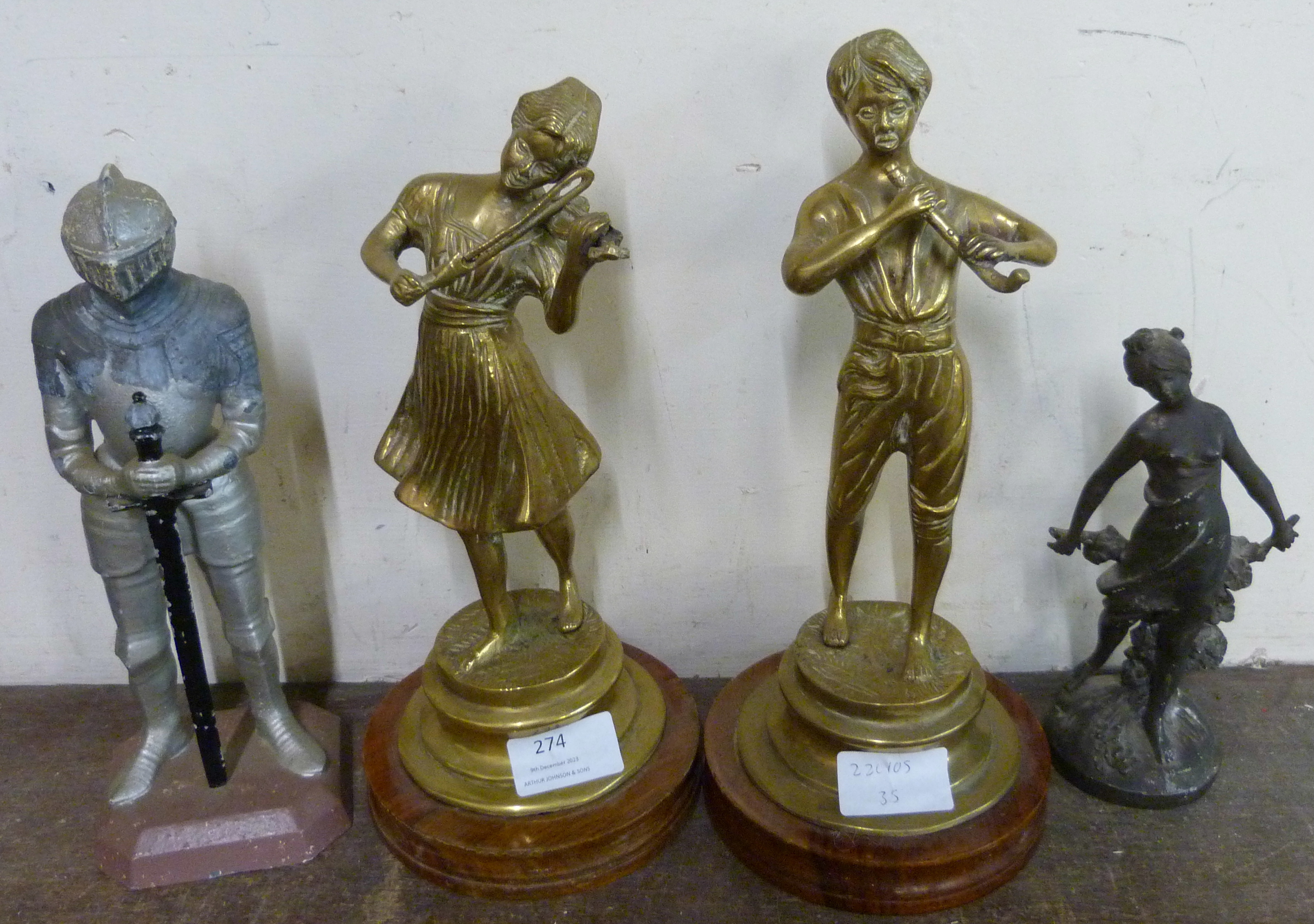 A pair of figures of musicians on wooden bases and two other figures of a lady and a knight