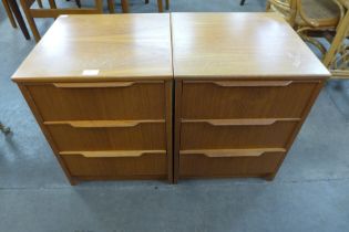 A pair of teak bedside chests