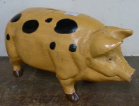 A large painted metal pig shaped money box