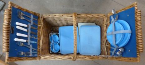 A wicker picnic hamper, containing Brexton picnicware