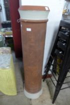 A tall terracotta chimney-pot