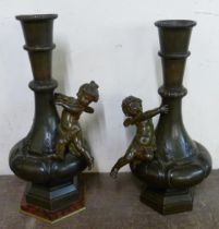 A pair of French style bronze cherub vases