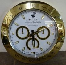 A Rolex style dealer's display wall clock