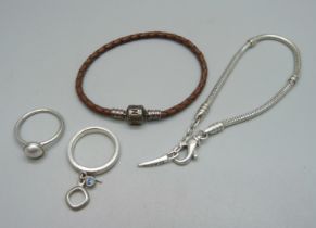 A Pandora charm bracelet, a silver Pandora ring, a silver Fossil ring and a silver Bacio bracelet