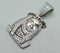 A stone set pendant depicting a Rastafarian, (tests as silver)