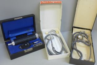 Two stethoscopes and an ophthalmoscope