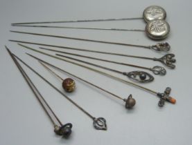 Nine silver hat pins, a plated hat pin and two hat pins decorated with dragonflies