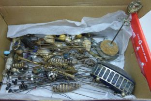 A box of approximately 120 mixed hat pins including a few silver/white metal examples and two hat