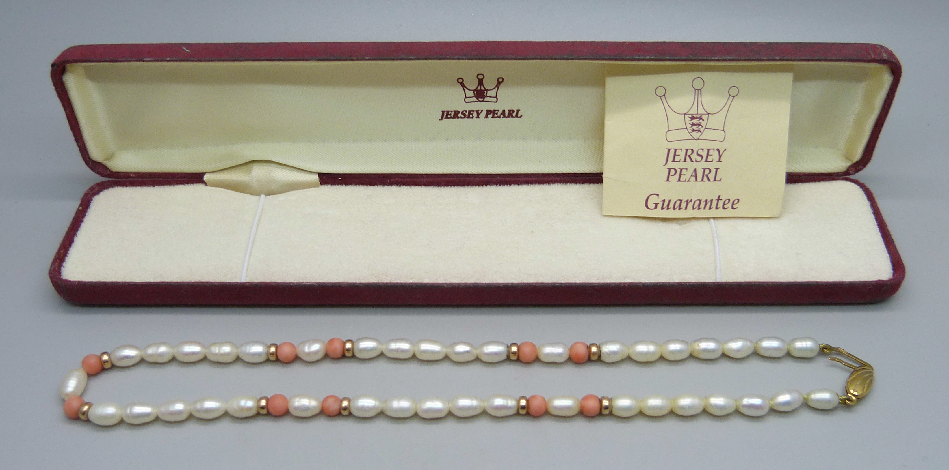 A Jersey Pearl necklace with 9ct gold clasp, boxed
