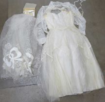 A wedding dress from Thames Board Mills, Purfleet, in original box and packaging with veil, shawl,