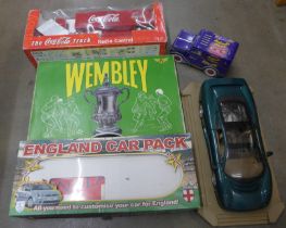 A Wembley board game, a Coca-Cola truck, an England car pack, a Maisto 1/18th scale model of a
