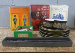 A box of plates, Dumbledore wand, three German uniform books, Bakelite reel and scale **PLEASE