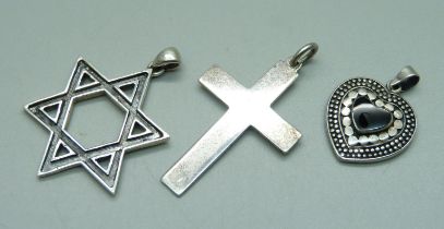 A silver Star of David pendant, a silver heart pendant and a cross pendant