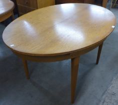 A teak oval extending dining table