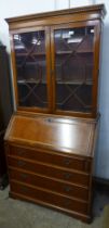 An Edward VII style inlaid mahogany bureau bookcase