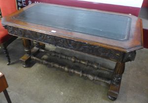 A Victorian Jacobean Revival carved oak and leather topped two drawer desk