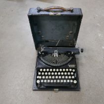 A vintage Qualcast lawnmower and a Remington portable typewriter
