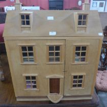 A wooden doll's house with accessories