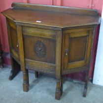 A carved oak hall table/ desk with chair