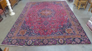 An eastern red ground rug, 350 x 237cms