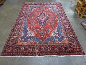 An Iranian red ground rug, 305 x 20.5cms