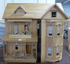 A large wooden doll's house with accessories