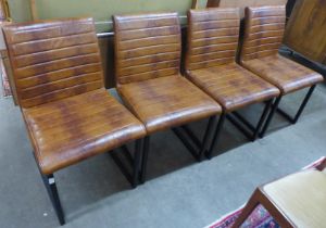 A set of four faux brown leather and black steel chairs