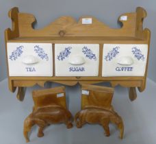 A pine tea, coffee and sugar rack and a pair of carved wooden elephant book ends