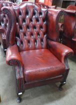 A Chesterfield red leather wingback armchair