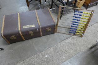 A vintage child's abacus and a steamer trunk