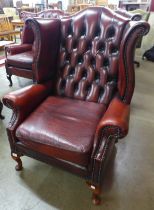 A Chesterfield red leather wingback armchair