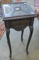 A Victorian carved oak jardiniere stand