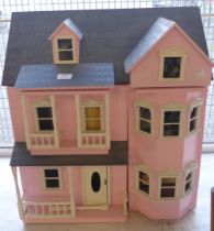 A painted doll's house with accessories