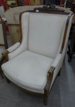 An early 20th Century French carved walnut and fabric upholstered fauteuil chair