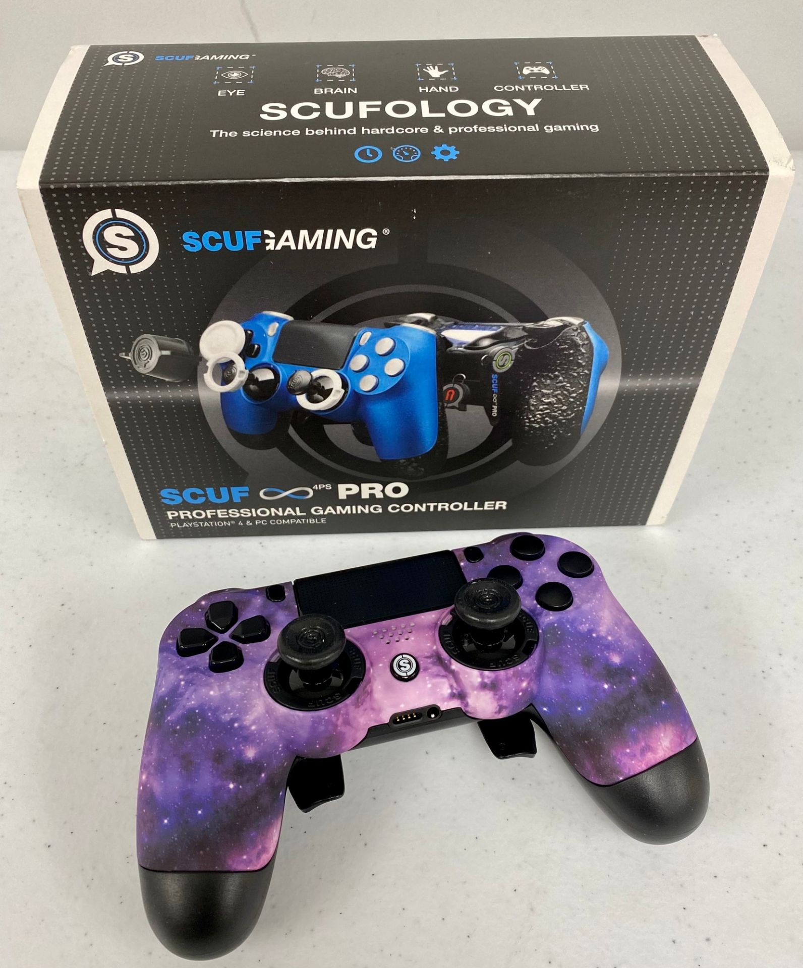 A boxed as new Scuf Gaming Infinity 4PS PRO Custom PlayStation 4 Controller in Purple Galaxy (Box op