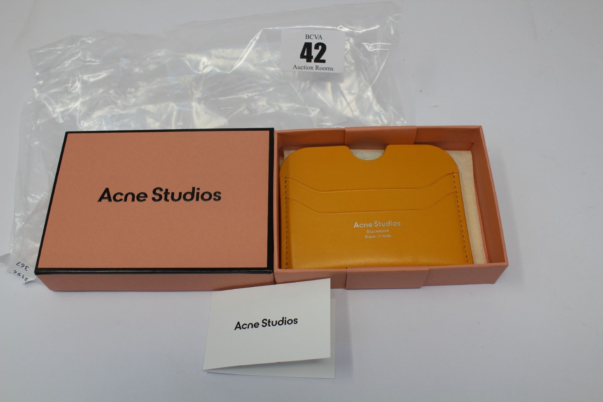 A boxed as new Acne Studios Leather Card Holder in Pumpkin Orange.