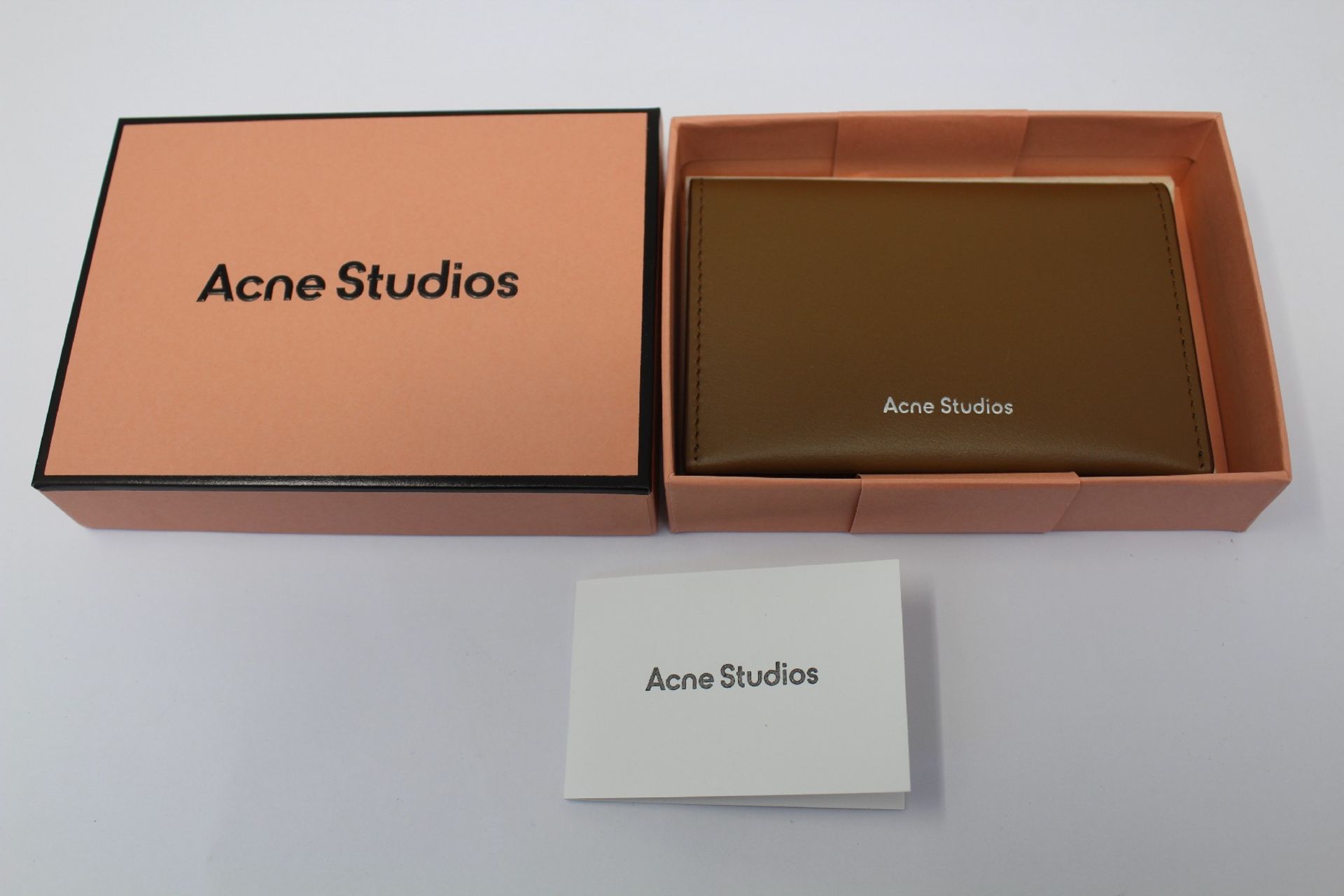 A boxed as new Acne Studios Folded Leather Card Holder in Camel Brown.