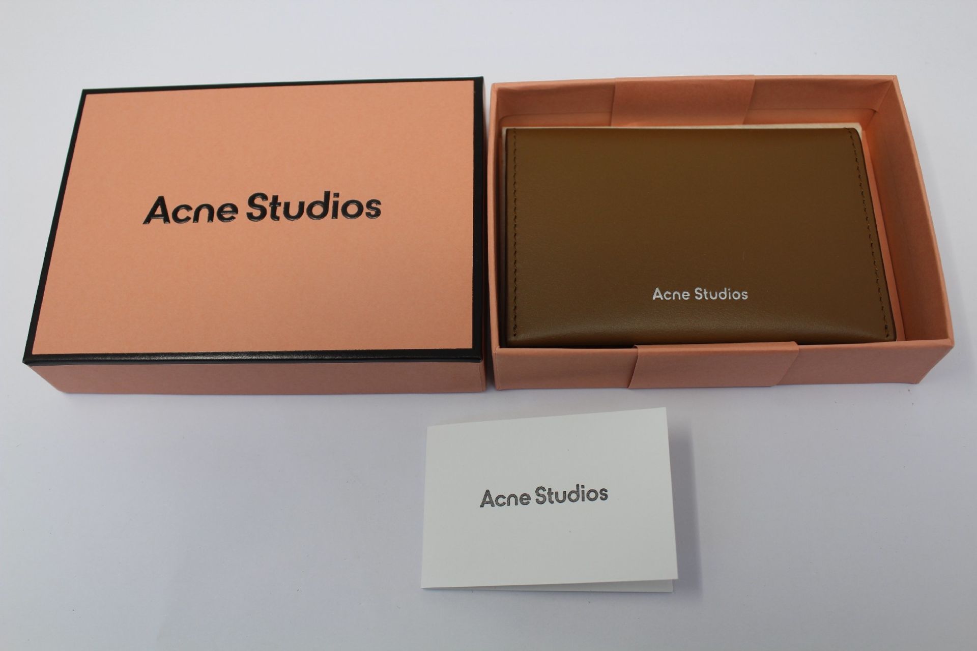 A boxed as new Acne Studios Folded Leather Card Holder in Camel Brown.