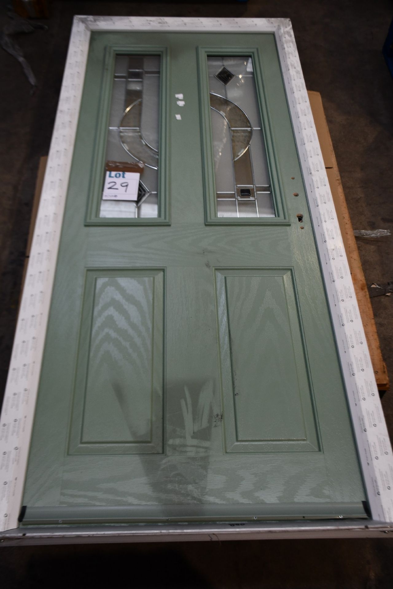 A composite door in green, 88cm x 20cm x 7cm.