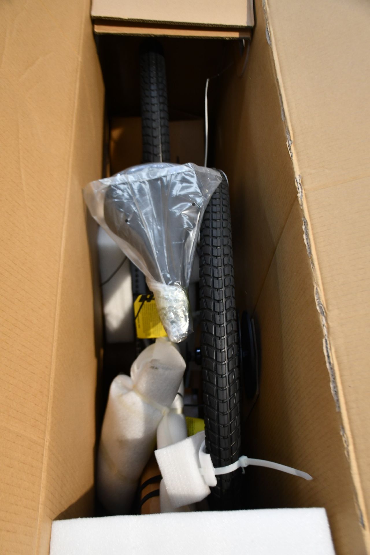 A boxed as new Radmisson 1 bike in white.