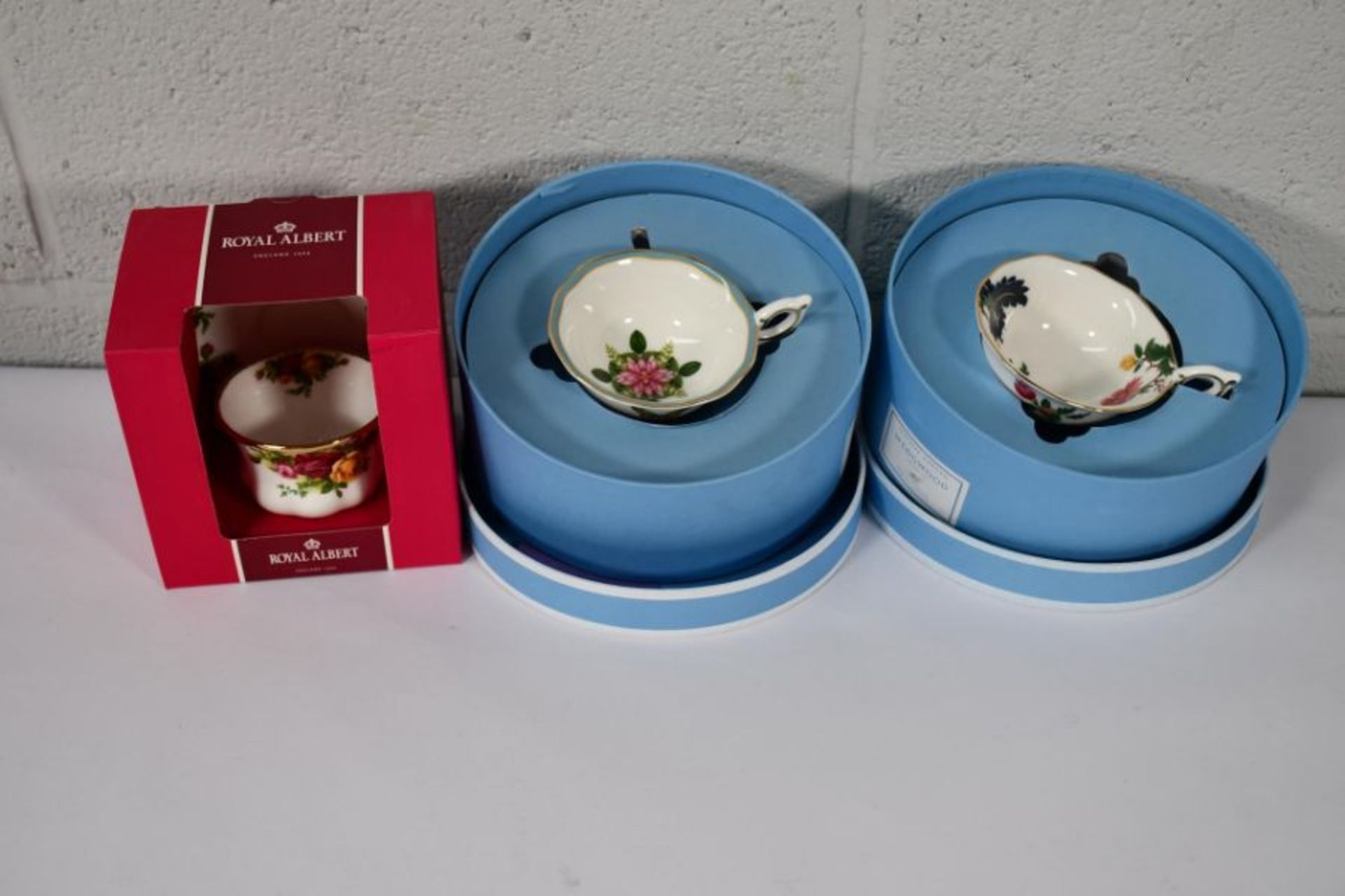 Two as new Wedgwood cup and saucer boxed sets and a Royal Albert cup and saucer