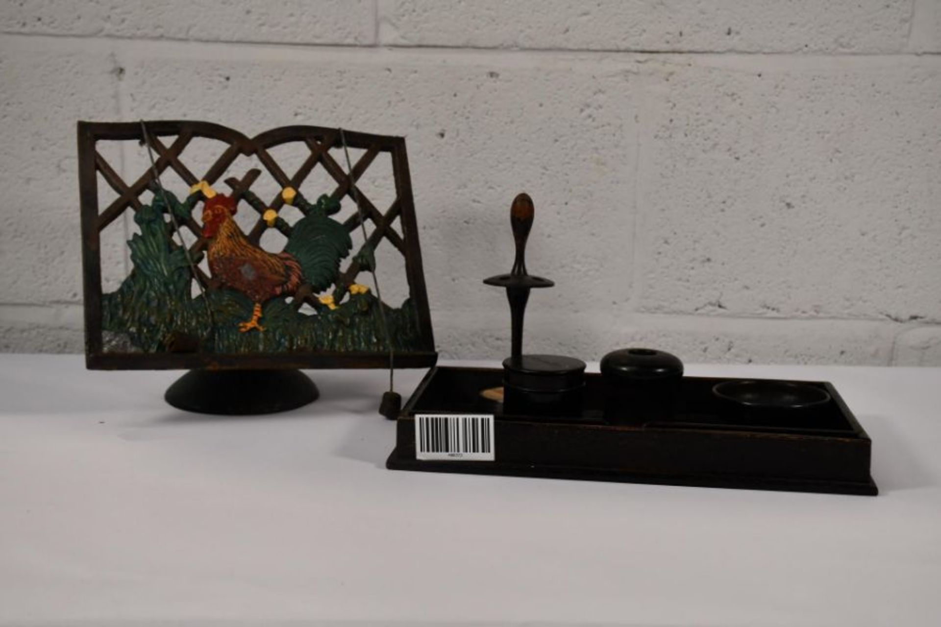 An Ebony dress table set and a cast iron cookery book stand with rooster design.