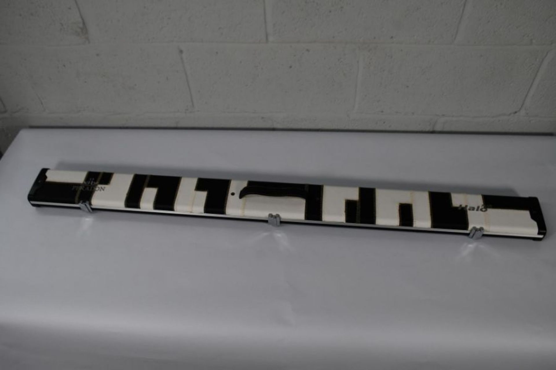 An as new Peradon 3/4 Halo Plus black and white patches cue case