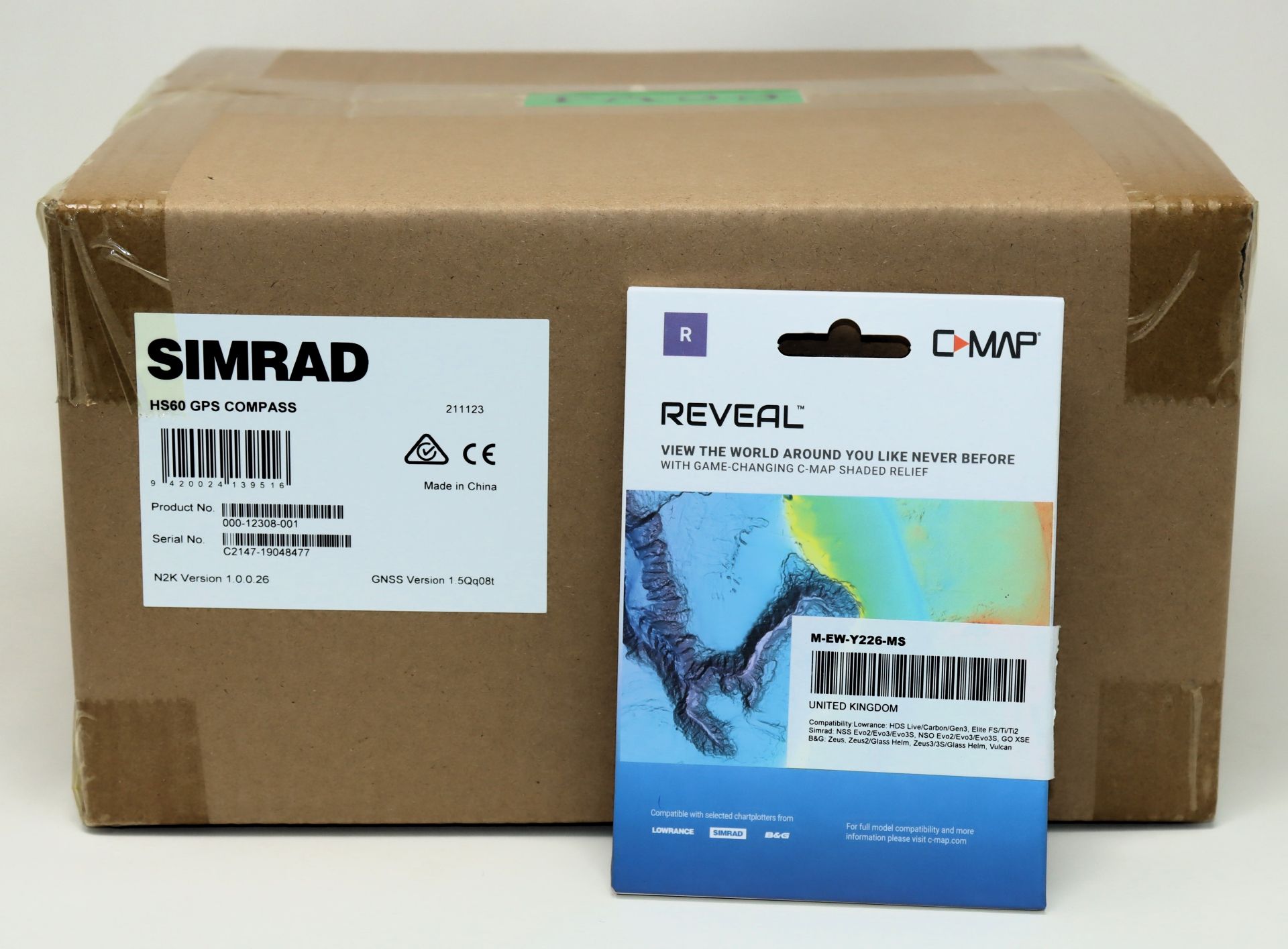 A boxed as new Simrad HS60 GPS Compass (P/N: C2147-19048477) with an as new C-MAP Reveal Chart Micro
