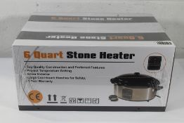 A boxed and sealed as new 6 Quart Stone Heater, UK Plug 230V.
