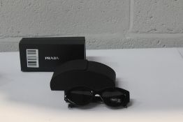A pair of Prada Cat Eye style black frame glasses BP00419569F).