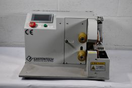 A pre-owned Eatontech EW-AT-401 automatic tape winding machine, 220V.